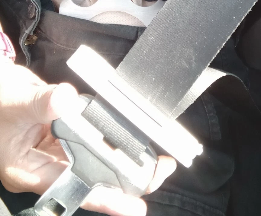 Seatbelt stoma protector in use in a car